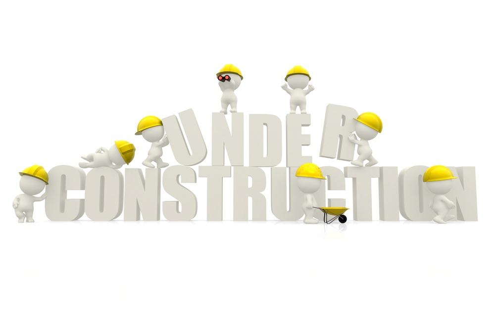 3D man wearing helmets with "under construction" sign isolated over white.jpeg